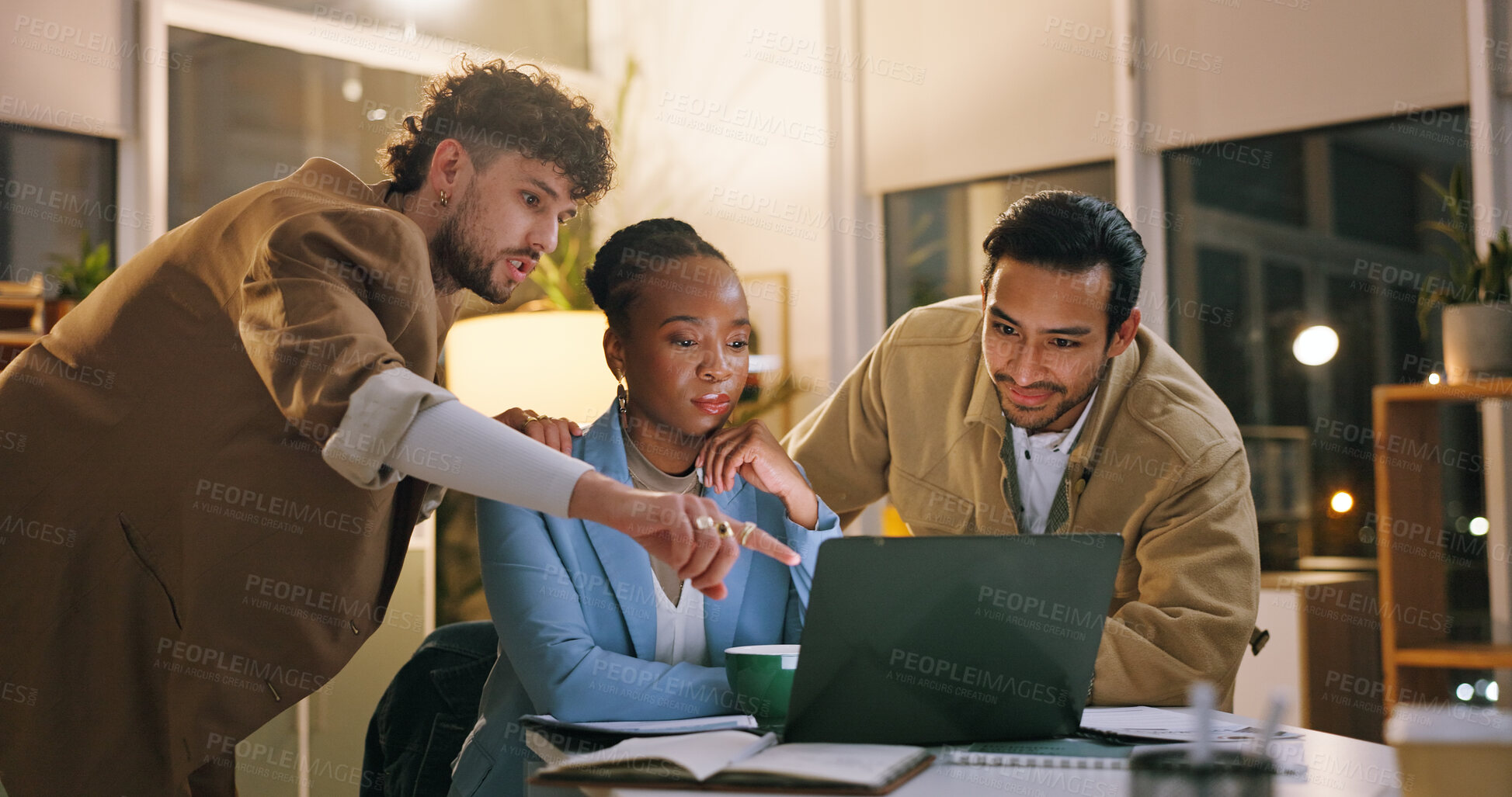 Buy stock photo Group, pointing and teamwork with laptop in business, working late or reporter with article deadline. Newsroom, online and people with smile for assignment, reading and creative with tech at night