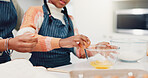 Hands, mother and child baking with eggs for learning, culinary skills and bonding together. Person, kid and helping with ingredients, preparing dough and teaching recipe for handmade snack at house