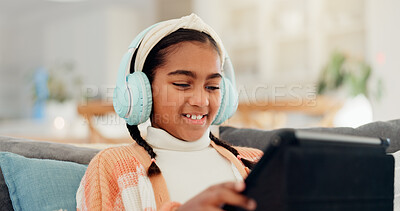 Buy stock photo Headphones, learning and tablet with girl child on living room sofa for interactive course. App, education and smile with happy kid in home for online lesson, remote study or virtual streaming