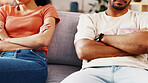 Crossed arms, couple and conflict in home with closeup, anger or tension with marriage problem. Woman, man and risk of divorce with relationship dispute, drama or argument crisis on sofa at house