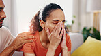 Woman, stress and man with comfort in home for loss, mistake or fail with anxiety in living room. Couple, partner consoling female person or support for mental health crisis, grief or emotion