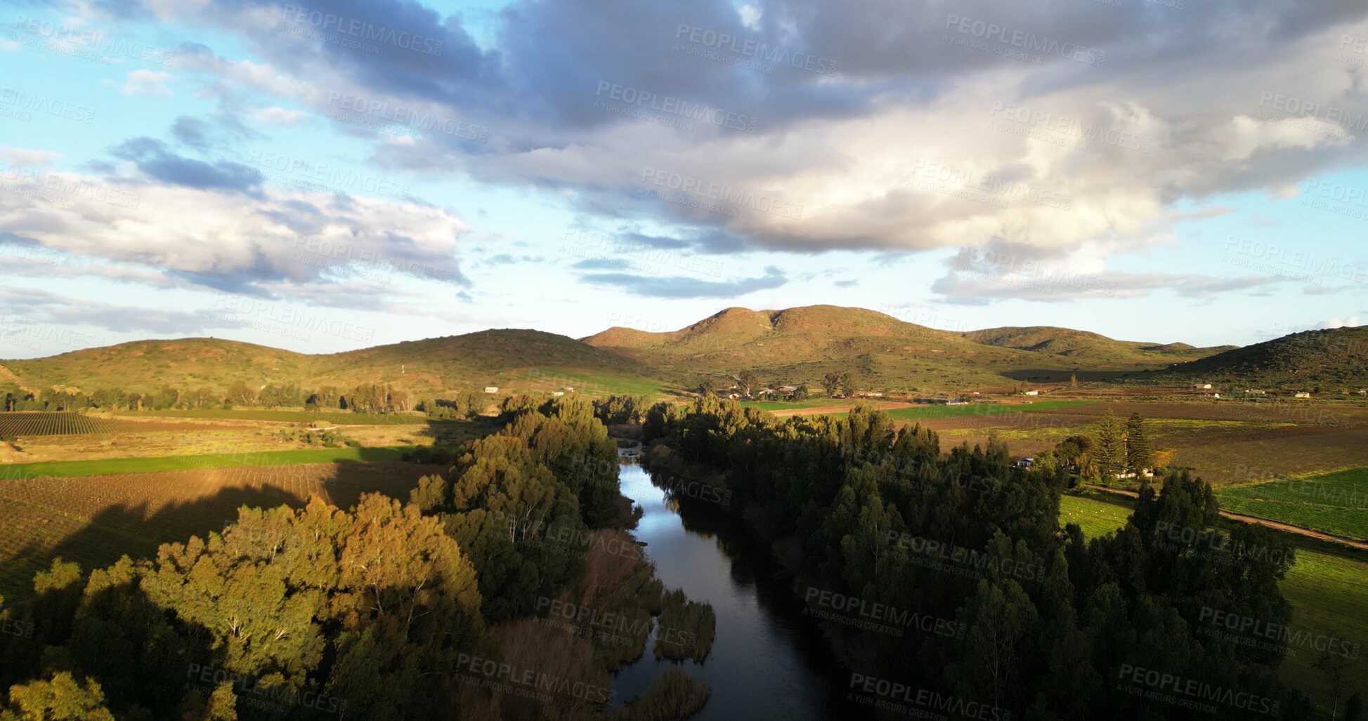 Buy stock photo River, above and countryside with nature, environment and blue sky with trees, sunshine and hills. Empty, clouds and landscape with lake, water and mountains with view and sustainability in Canada