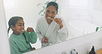 Mom, child and brushing with teeth in bathroom for dental hygiene, grooming or cleaning together. Mother, girl or playful daughter with smile, mirror or reflection for oral, mouth or gum care in home
