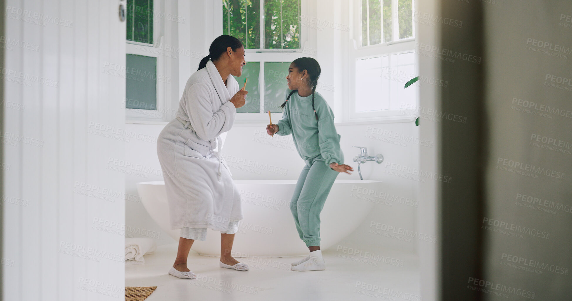 Buy stock photo Mom, girl and dancing with brush in bathroom for fun grooming or spa day together in home. Mother, child or singing with vibe, haircare or playful karaoke for beauty, love or morning routine in house