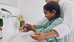 Mom, child and washing hands with soap in bathroom sink for cleaning, disinfection or hygiene. Mother, daughter or girl rinsing with water, tap or faucet for bacteria, germs or dirt removal in home