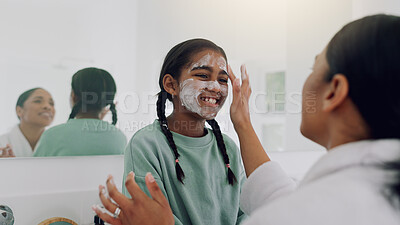 Buy stock photo Mom, happy girl and skincare with face mask in bathroom for beauty spa day or routine in home. Mother, helping or child with smile for facial treatment, grooming or salon cosmetics together in house