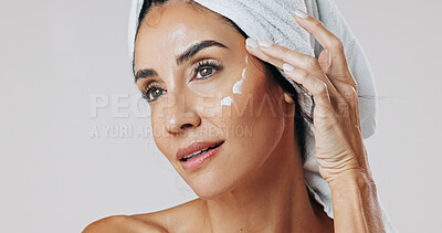 Buy stock photo Skincare, thinking and woman with lotion in studio, apply retinol moisturizer and anti aging treatment. Beauty, reflection and mature person with cream for hydration, glowing skin or white background