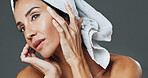 Glow, woman and dermatology in studio for anti aging, confidence and aesthetic in skincare. Mature person, treatment and towel with cosmetology, beauty or cosmetics with shine on gray background