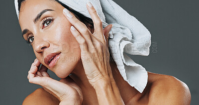 Buy stock photo Glow, woman and dermatology in studio for anti aging, confidence and aesthetic in skincare. Mature person, treatment and towel with cosmetology, beauty or cosmetics with shine on gray background