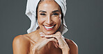 Portrait, woman and dermatology in studio for anti aging, confidence and aesthetic or skincare. Mature person, treatment and towel with cosmetology, beauty or cosmetics with space on gray background