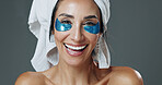 Skincare, portrait or woman with patches in studio, dark circles reduction or anti aging treatment. Beauty, smile or mature person with collagen eye mask for hydration, self care or gray background