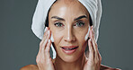 Woman, portrait and studio with moisturizer for skincare, hygiene or dermatology on a gray background. Female person, model or smooth skin with lotion, glow or shine for beauty cosmetics or hydration