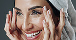 Smile, woman and skincare in studio for anti aging, confidence and aesthetic in dermatology. Mature person, treatment and towel with cosmetology, beauty or cosmetics with glow on gray background