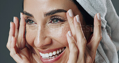 Buy stock photo Smile, woman and skincare in studio for anti aging, confidence and aesthetic in dermatology. Mature person, treatment and towel with cosmetology, beauty or cosmetics with glow on gray background