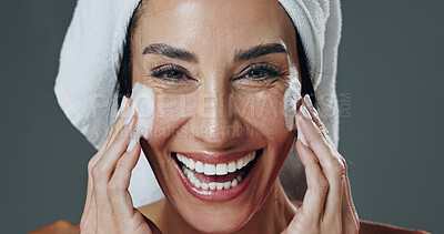 Buy stock photo Portrait, woman and face wash in studio with skincare, pore cleanser and smile for hydration benefits. Happy, mature person and foam soap for clean skin, dermatology and grooming on gray background.
