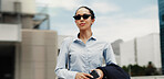 Business, woman and travel with sunglasses in city for work trip, commute or job opportunity. Female person, employee or traveler thinking with phone for career mission, ambition or insight in town