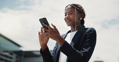 Buy stock photo Low angle, smartphone and black woman in city, smile and email for investment deal, typing and internet. Below, economy website and person in street, financial advisor and cellphone for trading info