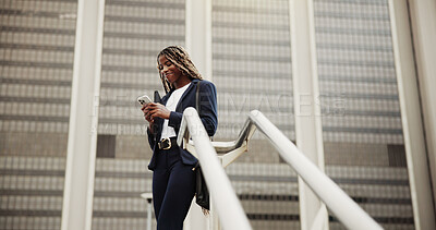 Buy stock photo Low angle, cellphone and black woman with smile, outdoor and email for trading deal, social media and app. Happy, investor or African person in city, funding approval and smartphone for economy info
