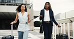 Business, people and walk with suitcase in city for travel, conference abroad and keynote speaker. Women, talk and tablet with luggage for work commute, international trip and teamwork in urban town