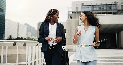 Buy stock photo Tablet, talking and walking with business women outdoor together for feedback, report or update. App, conversation and digital with employee people at building in city for online planning or research