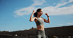 Athlete, woman and running celebration in city for fitness goals, cardio pace target and victory. Space, runner and excited with fist pump on bridge for exercise success, health progress and wellness