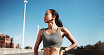Thinking, fitness and woman in city, rest and reflection for progress, exercise and wellness. Outdoor, runner and person with pride, training and workout for health benefits, wonder and contemplation