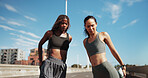 Fitness, legs and women in city for stretching, training and warm up for workout with blue sky. Sports, runner and people ready for wellness, mobility and exercise together for active hobby in town