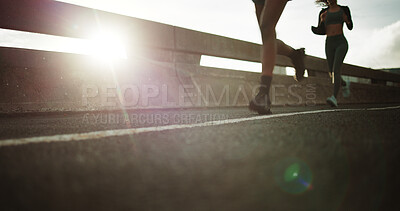 Buy stock photo Running, legs and people on bridge for fitness, performance and workout routine for wellness on road. Outdoor, athlete and training with endurance in city, flare and exercise together on street