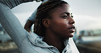 Exercise, stretching and black woman in city for fitness, cardio workout or thinking on bridge. Female person, overcast or runner warm up for wellness, sports and vision outdoor on urban street