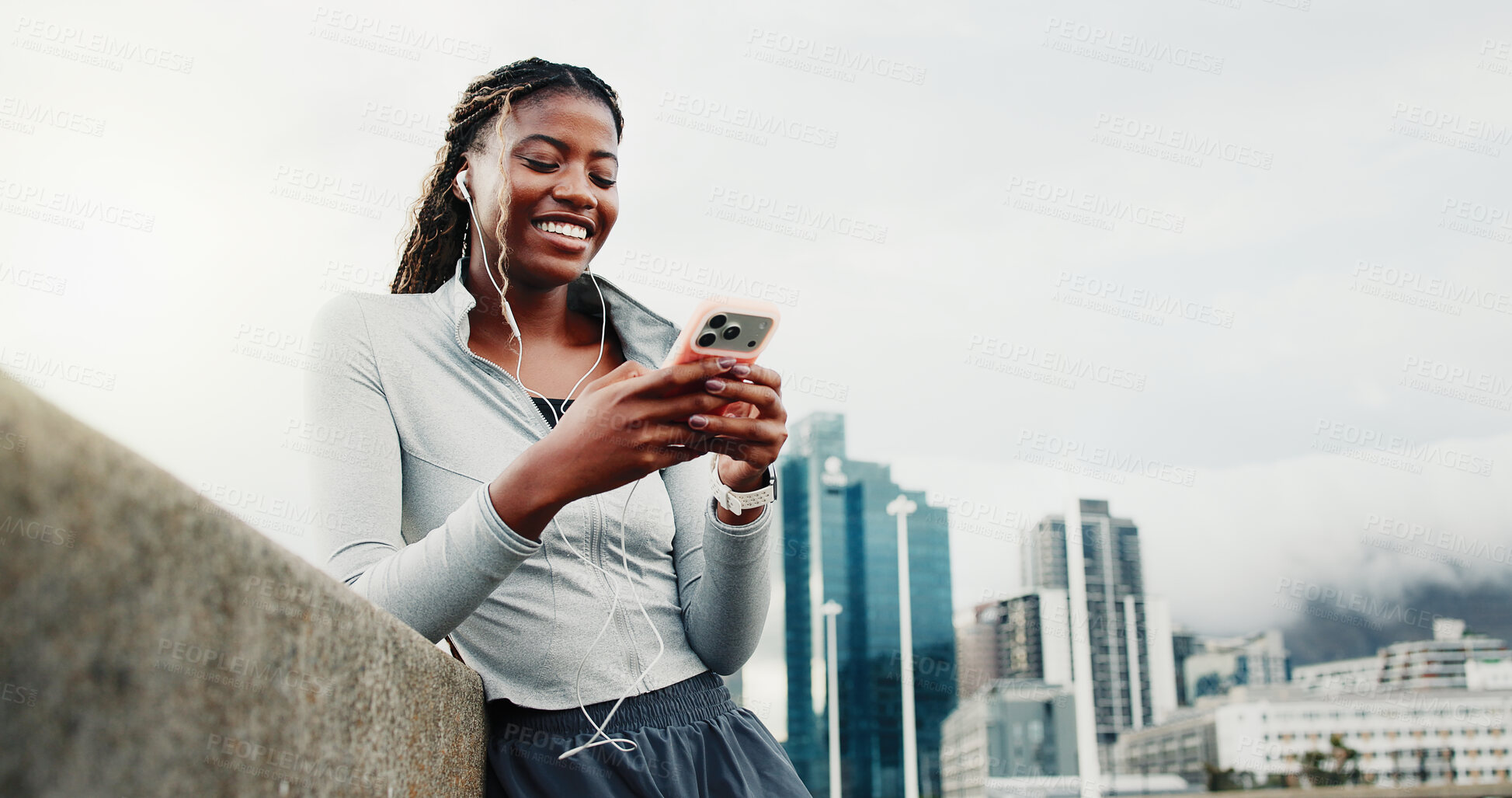 Buy stock photo Fitness, earphones and happy woman with smartphone on bridge, laughing or listening to music on web. City, space and black person with mobile for funny chat, low angle and audio on exercise break
