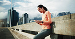 Bridge, earphones and woman with smartphone after exercise, scroll and listening to music on website. City, athlete and person with mobile for message, fitness and streaming audio on workout break