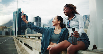 Buy stock photo Exercise, friends and women in city for selfie, cardio workout or social media post on bridge. People, overcast or runners training for wellness, sports and urban photography outdoor with a smile