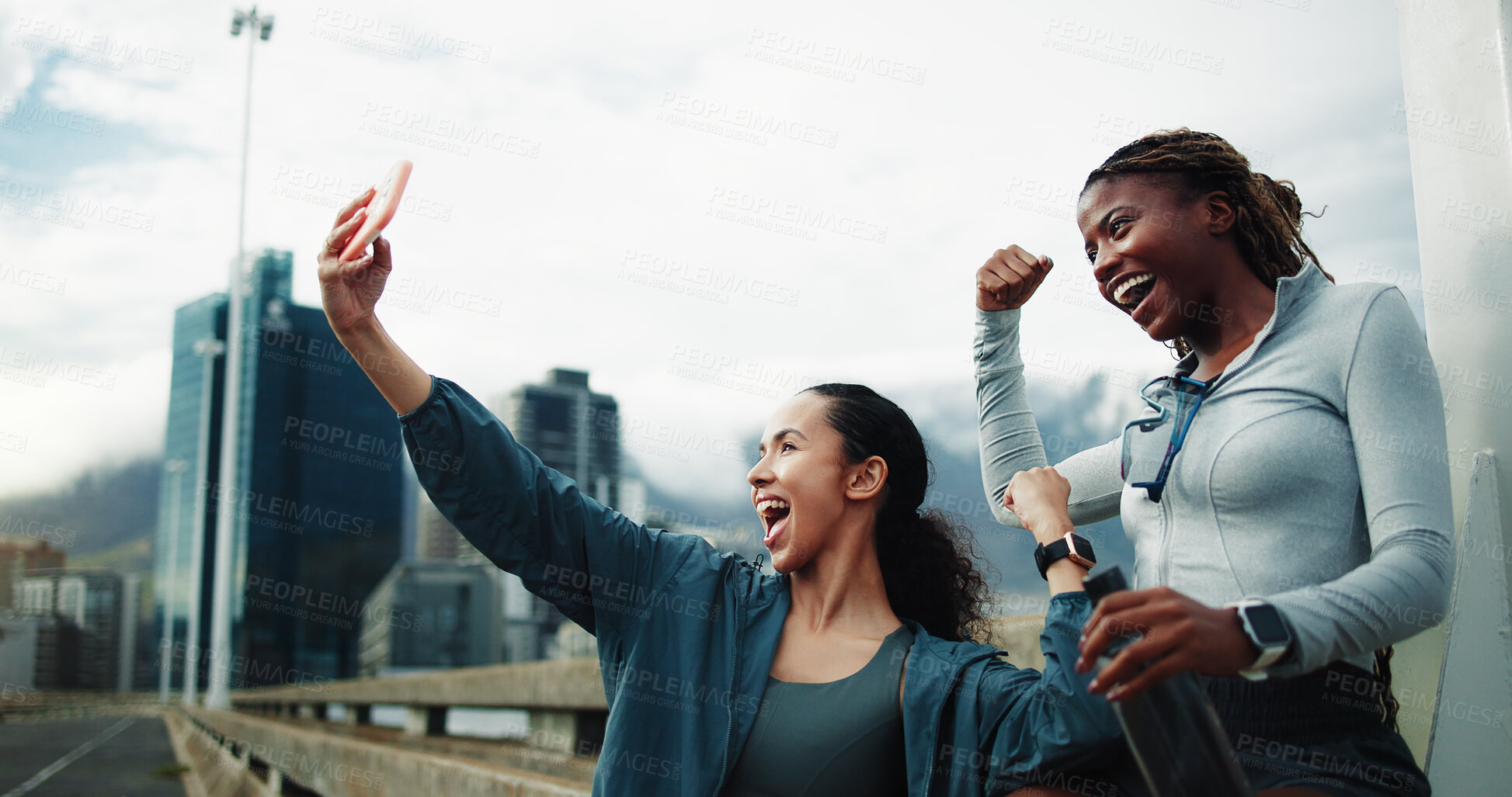 Buy stock photo Exercise, friends and fist pump in city for selfie, cardio workout or social media post on bridge. Women, overcast or runners celebrate wellness, win and urban photography outdoor with energy