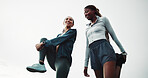 Women, friends and stretching for fitness, warm up and routine for outdoor training with smile. Low angle, chat and people with leg exercise for health, endurance or marathon practice together