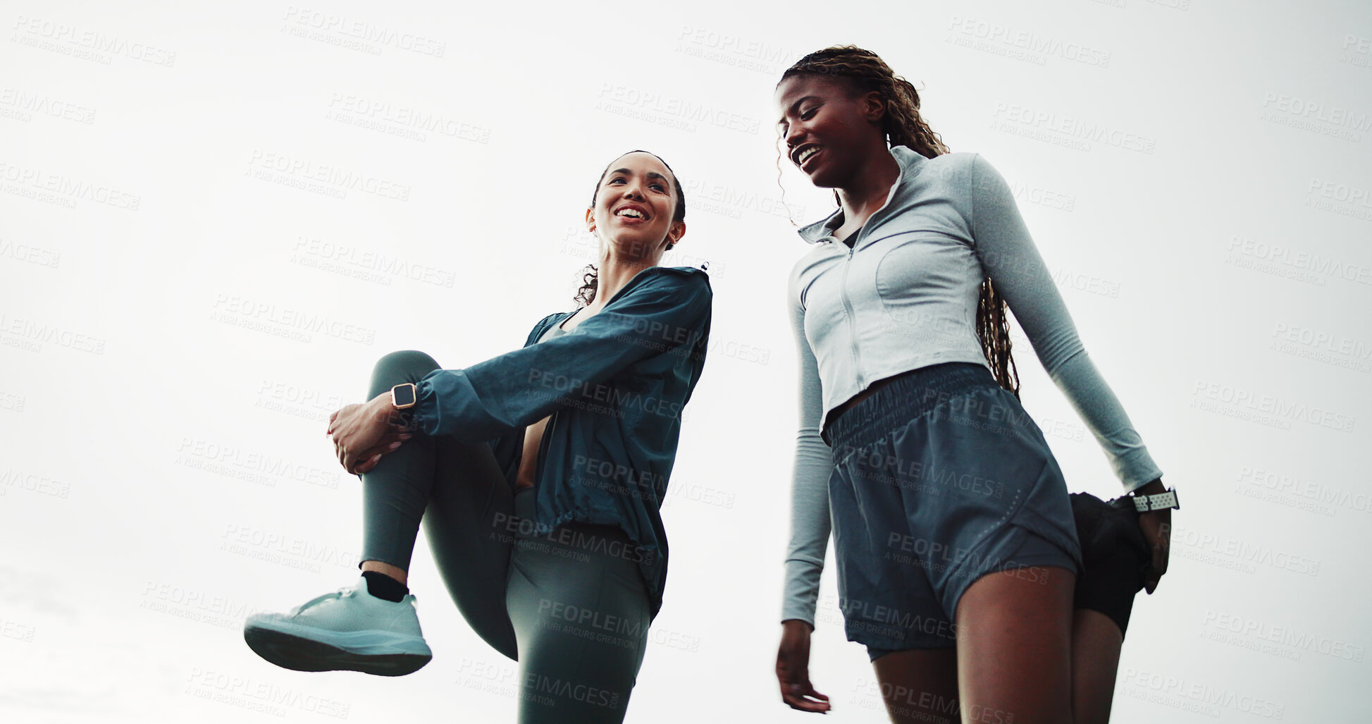 Buy stock photo Women, friends and stretching for fitness, warm up and routine for outdoor training with smile. Low angle, getting ready and people with leg exercise for health, endurance or start practice together