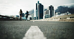 Woman, back and running in city for fitness with low angle, ground or asphalt for outdoor workout. People, friends and exercise for cardio challenge in winter, training and sprint on road in town