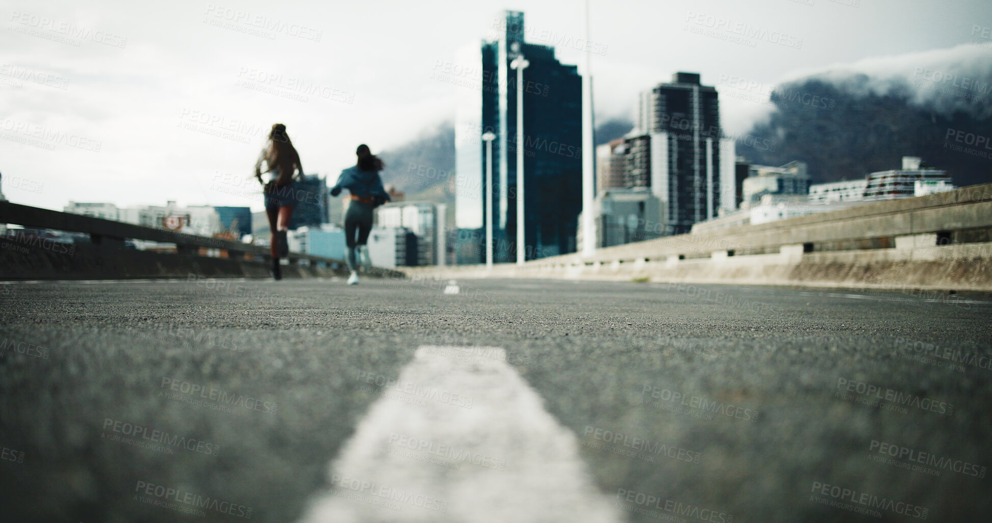 Buy stock photo Woman, back and running in city for fitness with low angle, ground or asphalt for outdoor workout. People, friends and exercise for cardio challenge in winter, training and sprint on road in town