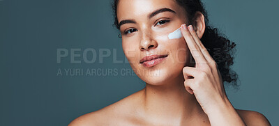 Buy stock photo Face cream, skincare and portrait of woman in studio with beauty, glow or wellness routine. Natural, mockup space and female person with facial lotion for dermatology treatment by gray background.