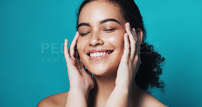 Buy stock photo Skincare, touch and woman with smile in studio, wellness glow aesthetic and smooth texture for beauty. Facial shine, dermatology or person with happiness for soft skin, self care or blue background