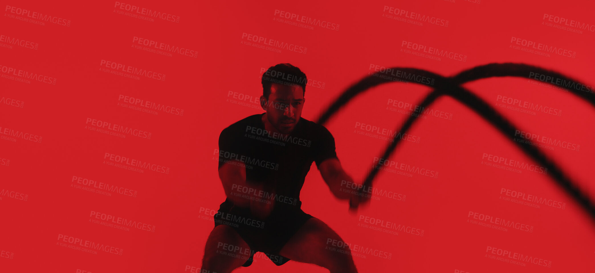 Buy stock photo Man, fitness and battle rope in studio with exercise, strength training and intense physical activity. Mockup space, person and workout with endurance challenge, cardio or wellness on red background