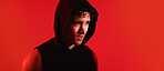 Fitness, man and sweating on studio with exercise break, thinking and training recovery for wellness. Mockup space, tired person and athlete with workout rest, hoodie or reflection on red background.