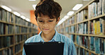 Boy, child and ebook in library with tablet, search website and online literature for development. Student, browse or reading at school with tech, storytelling app and education for knowledge growth.