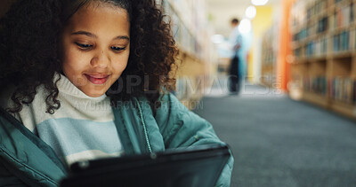 Buy stock photo Girl, child and browsing in library with tablet, ebook website and online literature for development. Kid, student and reading at school with tech, storytelling app and education for knowledge growth