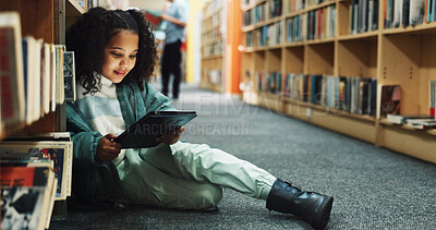 Buy stock photo Girl, kid and browsing in library with tablet, ebook website and online literature for development. Child, student and reading at school with tech, storytelling app and education for knowledge growth