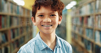 Buy stock photo Portrait, education and boy in library, smile and knowledge for child development. Student, braces and kid in school, learning and study for scholarship, books and information literacy for growth