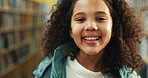 Elementary school, portrait or kid in library with smile, knowledge or scholarship in academic development. Education, child or student with pride, confidence or growth in learning opportunity.