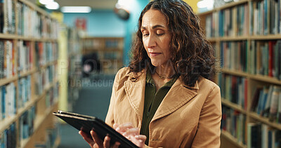 Buy stock photo Tablet, research and woman in library for inspection, inventory or checklist for books at university. Digital technology, service and mature female librarian checking stock online with app at college