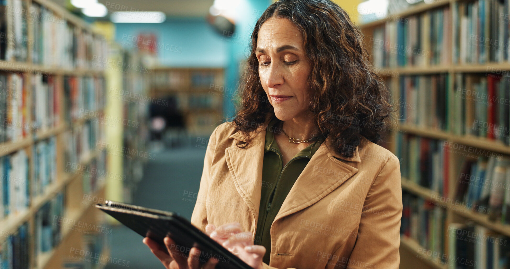 Buy stock photo Tablet, research and woman in library for inspection, inventory or checklist for books at university. Digital technology, service and mature female librarian checking stock online with app at college