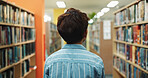 Education, child and back in library for learning, book search or language development for growth. Boy, student or academic in bookstore for literature, curriculum information or find course textbook