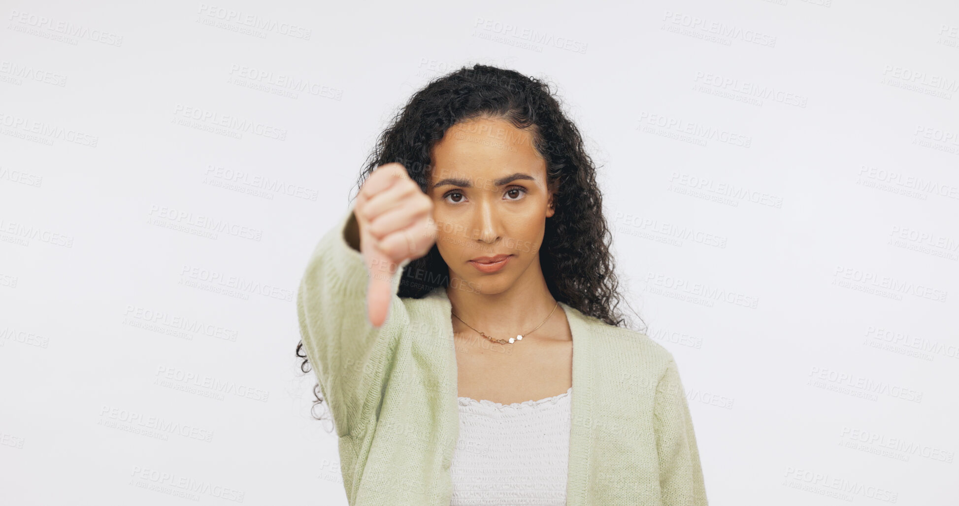 Buy stock photo Thumbs down, space and portrait of woman in studio with unhappy, disappointed and disagreement. Emoji, mockup and person with hand gesture for negative opinion, no and bad review on white background